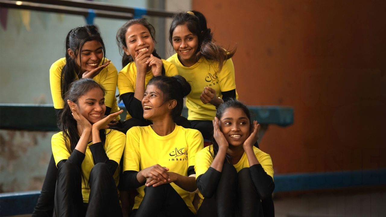 a group of teen gymnasts sitting together